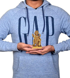 Man holding 3-inch brass Trimurti idol statue, gold figure centered on palms