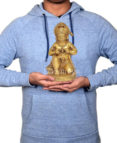Man holding 8 inch brass Hanuman JI sitting idol statue for scale