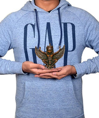 Brass Garuda hanging decor shown in hands, small winged ornament for home decor