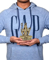 Brass Lord Shiva 4-inch sculpture held in hands, seated on ornate base