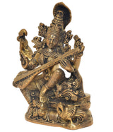 Maa Saraswati brass statue, angled view holding veena, intricate headdress and arm details