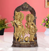 Brass Radha Krishna idol statue with artistic arch frame and base, seated figures