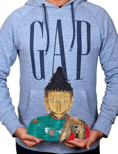 Dattatreya Buddha bust statue held over a blue hoodie, teal and red mosaic robe visible