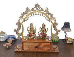 Brass arched mandir frame with hanging bells, wooden base drawer, with deity idols