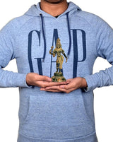 Person holding 6-inch brass Ardhanarishvara idol on palm, compact standing figure