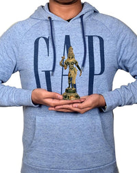 Person holding 6-inch brass Ardhanarishvara idol on palm, compact standing figure