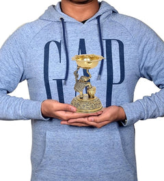 Brass elephant oil lamp diya held in hands, compact 5-inch pooja decor