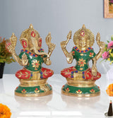 Brass Lakshmi-Ganesh idol pair: Ganesha with green robe, red accents, raised hands