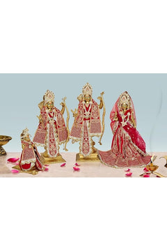3 idols: three ornate gold deity figurines in red embroidered outfits, painted eyes