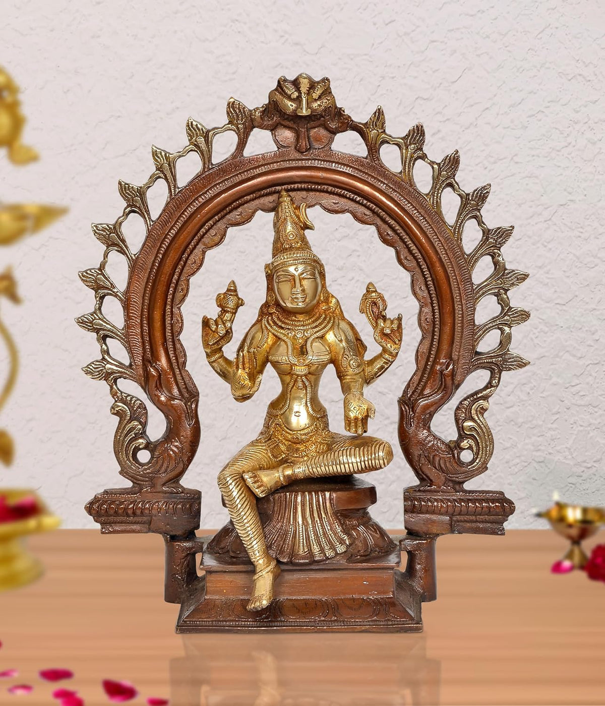 Brass Lakshmi idol statue with decorative arch, seated goddess with raised hands