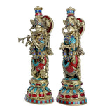 15-inch brass Radha Krishna idol set; side profiles with painted jewelry detailing