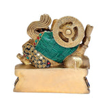 Brass Ganesha on asan with green drape and jeweled cuffs, side view