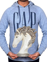 White polyresin horse head decor held in hands, gray hoodie visible behind