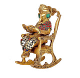 Brass Ganesha seated on chair, side view, turban, reading book on lap