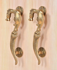 Brass yali design door handle pair, detailed curved levers with round base plates