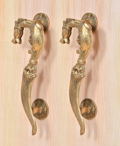 Brass yali design door handle pair, detailed curved levers with round base plates