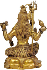 Brass Yogeshvara Shiva figure with long braided hair, holding trident, seated