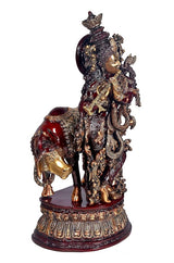 Brass Krishna cow murti figurine, side view on maroon base, detailed armor