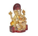 Brass Ganesha idol statue, three-quarter angle, red crown, gold details