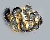 Abstract botanical iron decor with curled metal petals and teal cutout centers