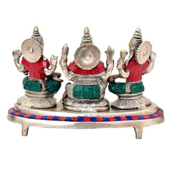 Back view of Ganesh-Lakshmi-Saraswati brass idols on multicolor round platform