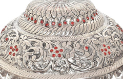 Close-up of silver carved chattar dome with red accents and textured scrollwork