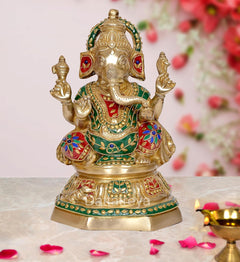 Brass Ganesha idol with colorful jewels and head adornments, four-armed pose