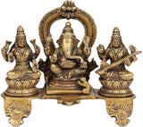 Brass Lakshmi-Ganesha-Saraswati figurine, centered Ganesha with raised halo arch