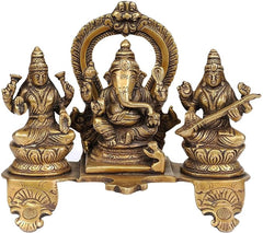 Brass Lakshmi-Ganesha-Saraswati figurine, centered Ganesha with raised halo arch