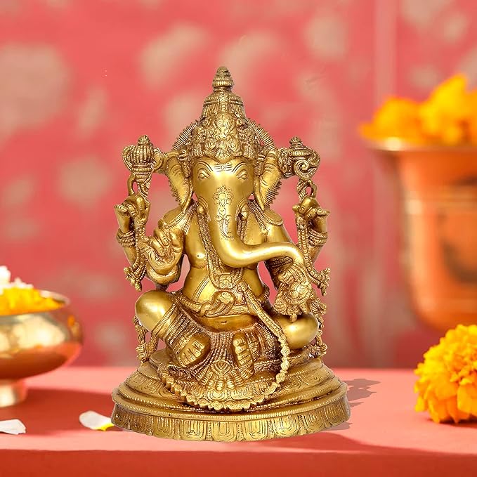 Brass Ganesha statue idol seated on ornate base, four arms holding symbols