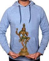 Small brass Ardhanarishvara Shiva-Parvati statue held in hands in front of hoodie