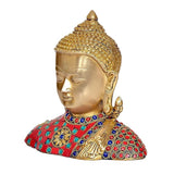 Gold Buddha bust with ornate crown, closed eyes; multicolor jeweled collar and red garment