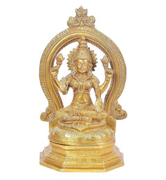 Brass Saraswati statue seated with halo arch, raised hands and veena-like instrument