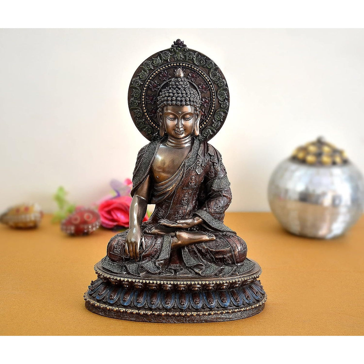 Resin Buddha sculpture, seated with ornate halo and blue-trimmed base, 11 in