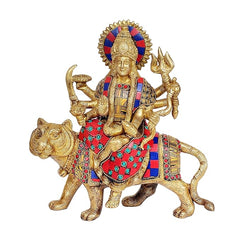 Brass Durga statue seated on lion with trident raised, multicolor saree details