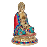 Seated Buddha sculpture with multicolored robe draped over golden torso