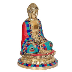 Seated Buddha sculpture with multicolored robe draped over golden torso