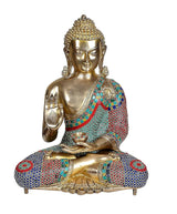 Seated brass Buddha statue with Abhaya mudra hand gesture and patterned multicolor robe