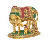Close view gold Kamdhenu cow with calf, Bal Krishna and kneeling figures, ornate jewels