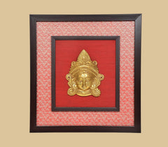 Brass Maa Durga face idol wall hanging, gold deity head relief centered on red panel