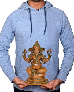 Brass Ganesha idol held in hands, seated figure on round base