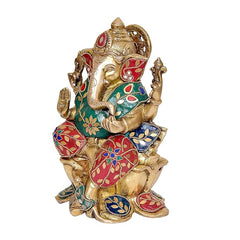 Brass Ganesha idol side view, detailed face, teal torso and red decorative sash