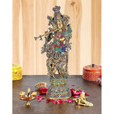 Brass Krishna murti with flute, ornate multicolor headdress and detailed jewelry