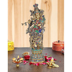 Brass Krishna murti with flute, ornate multicolor headdress and detailed jewelry