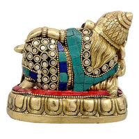 Brass resting Ganesha idol, back view, patterned blue bands and circular white accents, 4 in