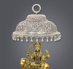 Carved metal chatta with ring handle; silver dome with red gem-like details