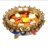 Brass urli bowl with bells, topped with multicolour flowers