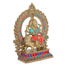 3/4 view Durga Maa brass statue with jeweled colors, lion figure, and ornate back