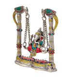Side view of Lord Ganesha on swing jhula, red base platform with colorful inlays