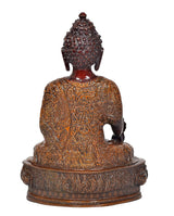 Rear view of meditating Buddha statue, dark red head and gold engraved garment